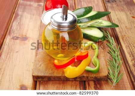 oil and vegetables served on wood cutting board