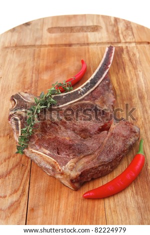 meat food : grilled beef spare rib on wooden plate with thyme isolated over white background