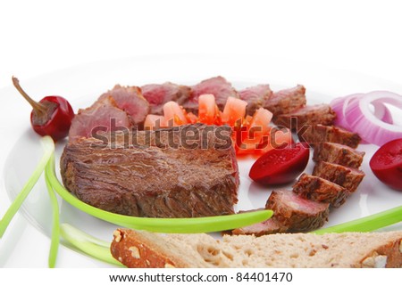 meat food : grilled fat meat served on white plate with tomatoes , sprouts and bread isolated on white background