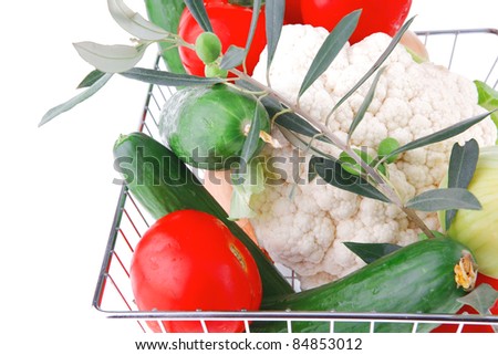 ripe vegetables in metal store basket on white