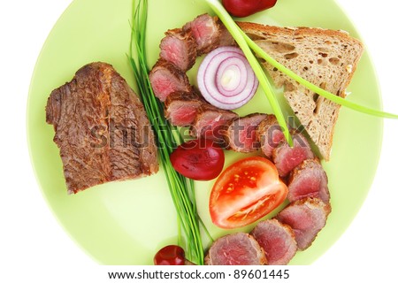 meat food : grilled fat meat served on green plate with tomatoes and sprouts isolated on white background