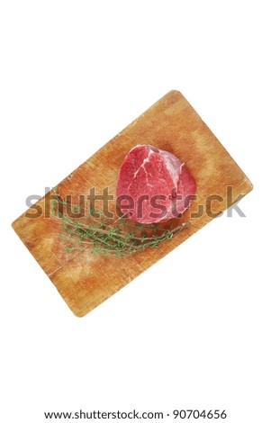 fresh red meat : raw beef fillet on wooden board with thyme ready to prepare . isolated over white background