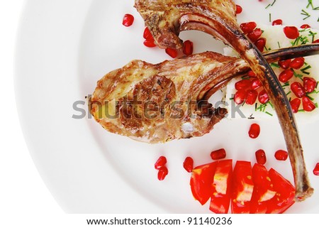 meat portion: barbecued ribs served with rice and tomatoes on plate over white background