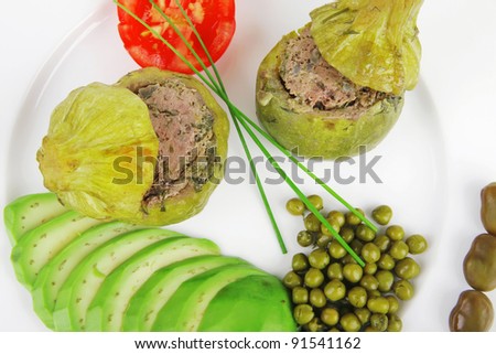 meat meal: round zucchini filled with mince meat over white dish