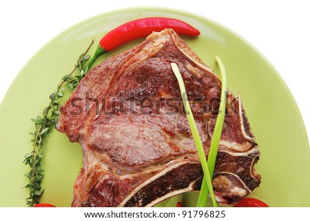 savory : grilled spare rib on green dish with thyme pepper and tomato isolated over white background
