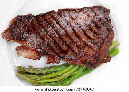 meat table : rare medium roast beef fillet and asparagus served on white dish