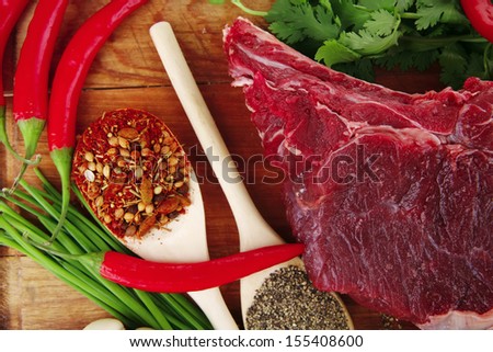 uncooked meat : raw fresh beef pork rib ready to cooking with garlic and red hot pepper over wood isolated over white background