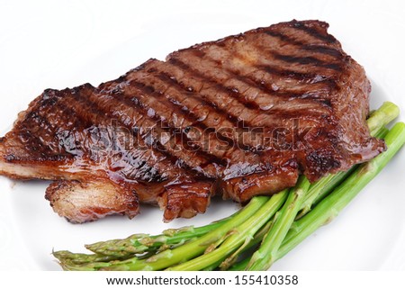 meat table : rare medium roast beef fillet with asparagus served on white dish