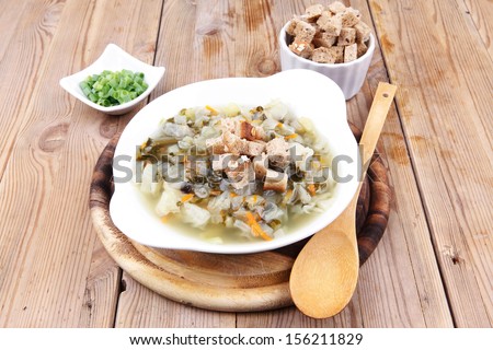 diet food : hot vegetable soup with bread  crackers in white bowl on wood stand over table