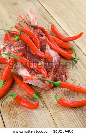 natural low fat fresh spare ribs : raw lamb with red chili pepper on wooden table