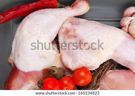 raw chicken legs with tomatoes and thyme on yellow ceramic pan ready to cooking isolated on white background health care low fat meat