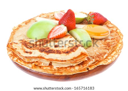 sweet food : big thin pancake with honey strawberries and apple isolated over white background
