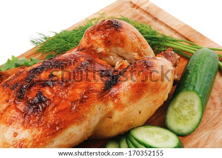 baked meat : fresh whole chicken with black olives and raw tomatoes on wooden board isolated over white background
