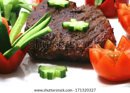 fresh grilled big beef meat steak on white plate with tomatoes isolated on white background