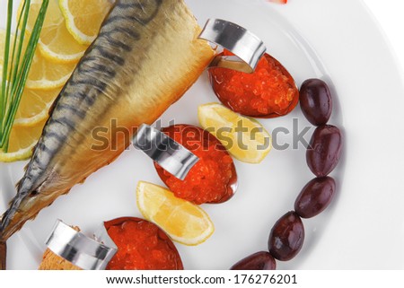 diet food - red caviar and smoked mackerel fish with lemon tomatoes and bread on white china plate isolated over white background