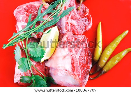 fresh raw beef red meat fillet medallion chunks on red plate isolated over white background