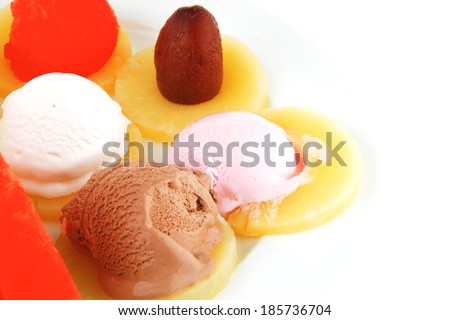 watermelon plum and slice of pineapple and chocolate and fruit ice cream on white plate isolated over white background