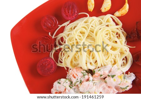 fresh rose wild salmon baked in cream cheese sauce with italian pasta and red hot pepper on square plate isolated over white background