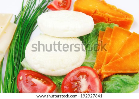 fresh aged cheese : parmesan roquefort and gruyere with soft feta on plate with isolated over white background