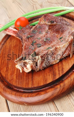 meat savory : grilled beef ribs served with green chives and cherry tomato over wood