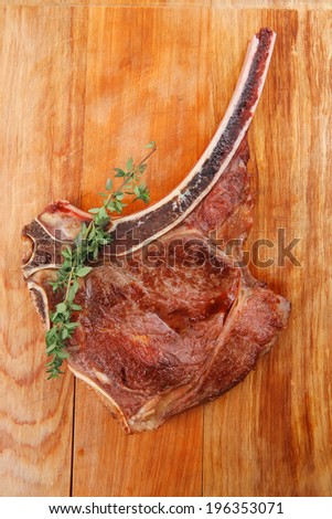 meat food : roast rib on wooden plate with thyme