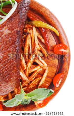 meat food : grill beef on potato chips with fresh tomato and hot green peppers on wood plate isolated on white background
