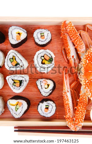 California Roll with Avocado and Salmon, Cream Cheese and Raw Salmon inside. on wooden plate with live crab  . isolated over white background . Maki Sushi and Sashimi