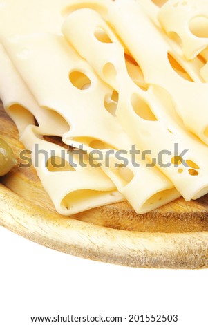 gold edam cheese sliced on wooden platter with olives and tomato isolated over white background