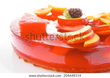 image of cold red jelly cake with nectarine and peach