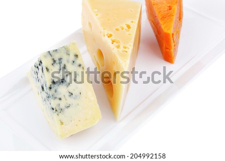 aged parmesan roquefort and gruyere chops delicatessen cheeses on white plate isolated over white background