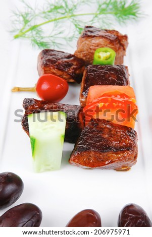 european food: roast beef meat goulash over white plate isolated on white background with vegetables