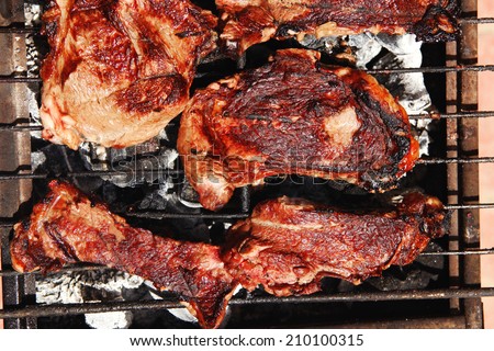 fresh hot bbq grill red beef meat steak ready on grid over charcoal with marks