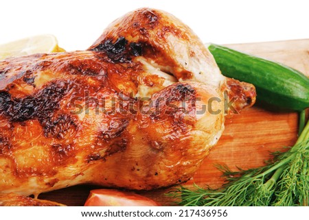 baked meat : fresh whole chicken with black olives and raw tomatoes on wooden board isolated over white background
