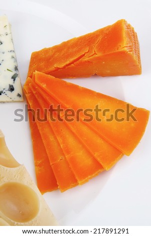 aged parmesan roquefort and gruyere chops delicatessen cheeses and slices on plate isolated over white background