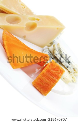 aged parmesan roquefort and gruyere chops delicatessen cheeses and slices on plate isolated over white background