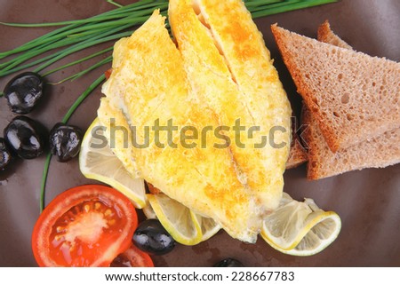 grilled fish fillet served with tomatoes,olives and bread