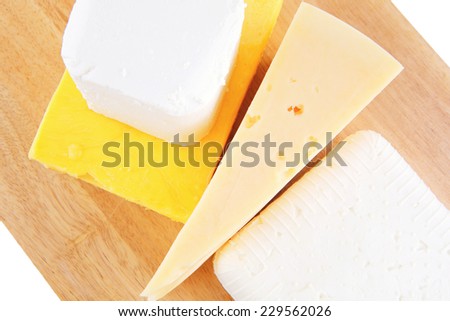 goat cheeses and yellow on wooden board