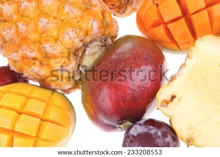 exotic diet food - set of lot of tropical fruits include pineapple mango and red plum isolated over white background