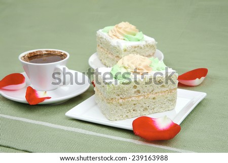 sweet food : milked cream cake with roses and hot black coffee cup