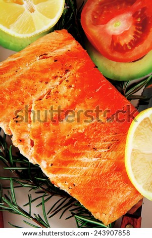 healthy food: hot baked salmon piece served over glass plate isolated on white background