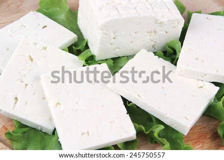 white goat cheese served on wooden plate