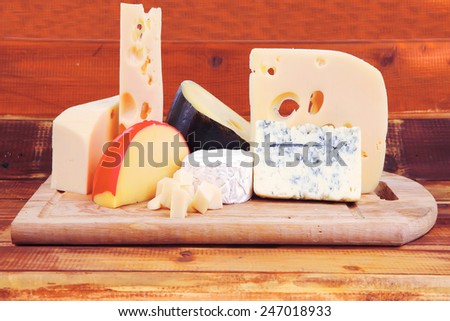 different cheeses served on wooding cutting board