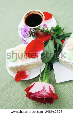 sweet food : milked cream cake with roses and hot black coffee cup
