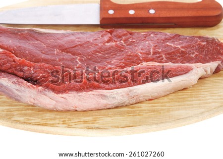raw meat beefsteak fillet with knife on wood isolated over white background