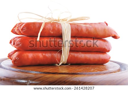 smoked beef sausages served on a wooden plate