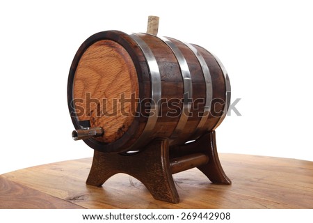 hand made wooden barrel full whiskey with crane over wooden table isolated over white background