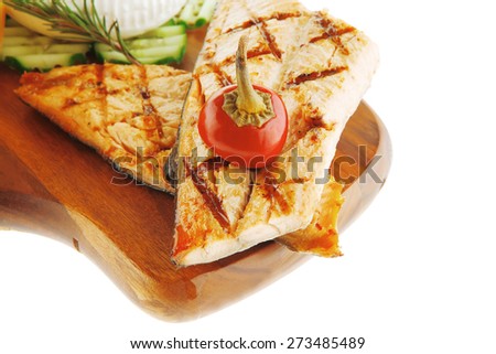 grilled sea fish salmon with french edam gorgonzola and soft feta goat cheeses on wooden plate isolated over white background