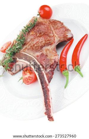 savory : grilled spare rib on white dish with thyme pepper and tomato isolated over white background