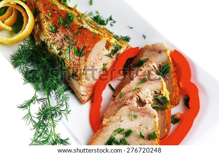 healthy dinner: grilled sea tuna fish with lemon and vegetables on white china plate isolated over white background