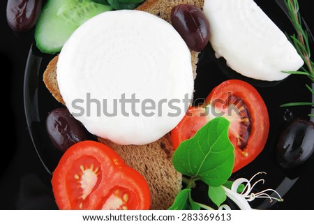 light cheese with vegetables on bread over white